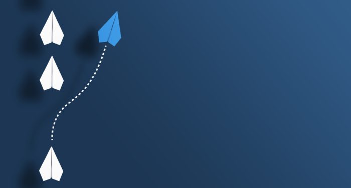 Paper,Planes,In,A,Row,On,Blue,Background,And,One